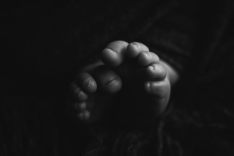 black and white closeup of baby toes, newborn photography