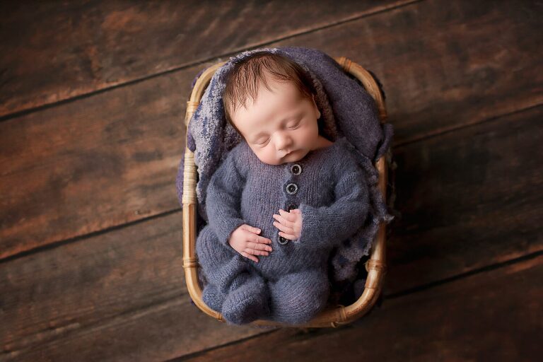 baby boy asleep in basket