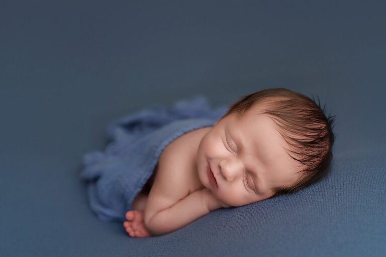 newborn photographer texas, baby boy asleep on tummy with blue wrap